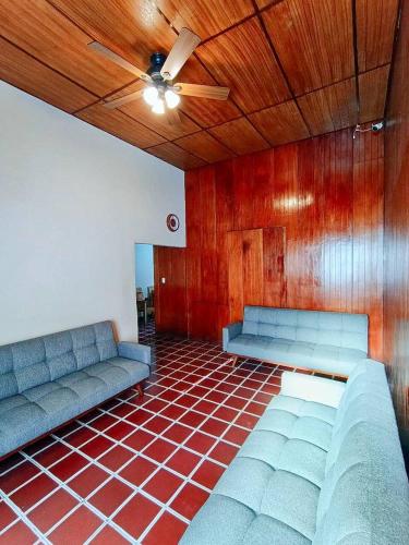 a room with two couches and a ceiling fan at Casa Central de Santa Ana in Santa Ana