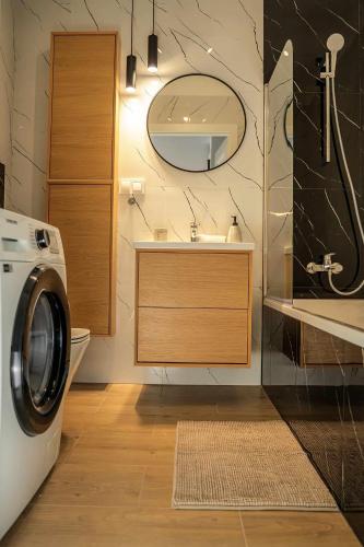 a bathroom with a washing machine and a sink at Duży apartament in Gdańsk