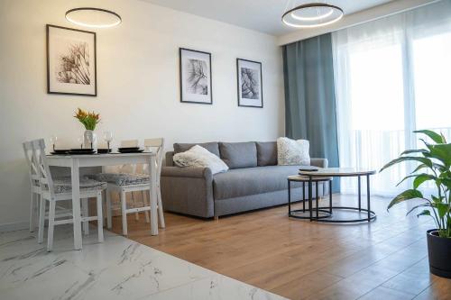 a living room with a couch and a table at Duży apartament in Gdańsk