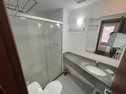 a bathroom with a glass shower and a sink at UH 110 Flat Hotel Rua Maestro Cardim - Bela Vista in São Paulo