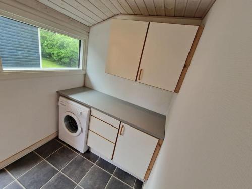 a tiny house with a washer and dryer in it at Holiday house by a fantastic beach and free WiFi in Slagelse