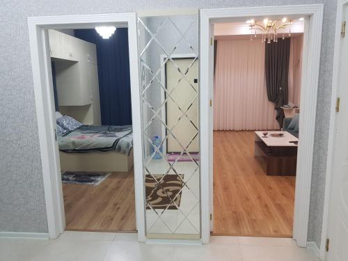 a door leading into a room with a bedroom at У Эльмана in Sumqayyt