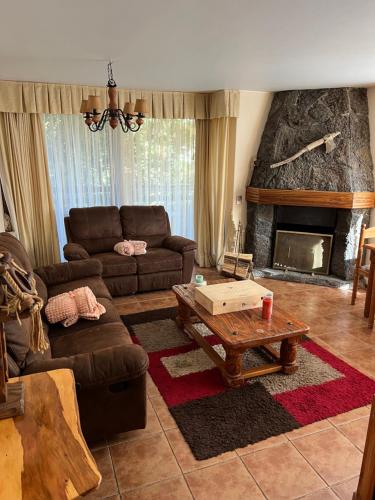 a living room with a couch and a fireplace at Departamento Pucon in Pucón