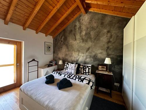 a bedroom with two beds and a wall at Monte São Francisco in São Francisco da Serra