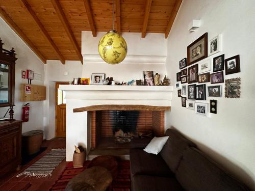 a living room with a couch and a fireplace at Monte São Francisco in São Francisco da Serra