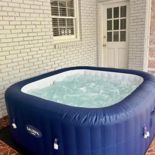 a large blue tub in front of a house at Queen Suite - Indoor Hot Tub - WiFi in Atlanta