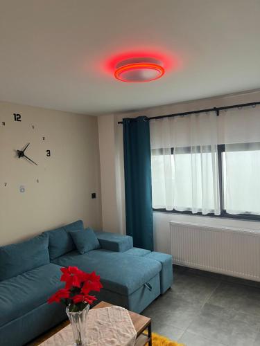 a living room with a blue couch and a red light at ElatoVillage in Elatochori