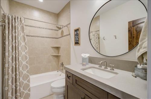 a bathroom with a sink and a toilet and a mirror at Black Rock Ridge 14202 by Moose Management in Park City