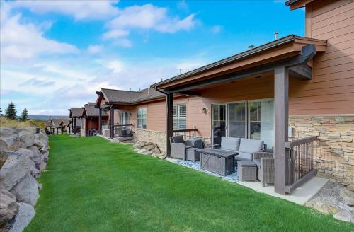a home with a patio with chairs on a lawn at Black Rock Ridge 14202 by Moose Management in Park City