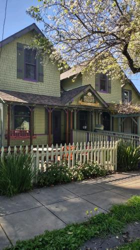 a white picket fence in front of a house at San Luis Obispo Hostel in San Luis Obispo