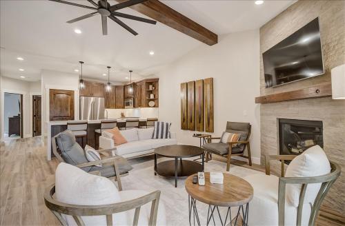a living room with white furniture and a fireplace at Black Rock Ridge 14202 by Moose Management in Park City