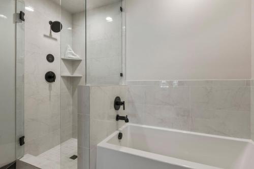 a bathroom with a white tub and a shower at Black Rock Ridge 14488 by Moose Management in Park City