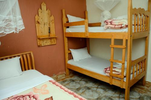 two bunk beds in a room with two beds at Gorilla African Guest House in Entebbe