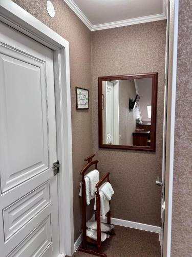 a bathroom with a mirror and a towel rack at Hotel Korona in Kropyvnytskyi