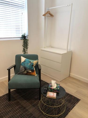 a living room with a chair and a table at On The Avenue Apt 3 in Nottingham