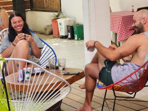 a man and a woman sitting in lawn chairs at Casa Colibri Palomino in Palomino