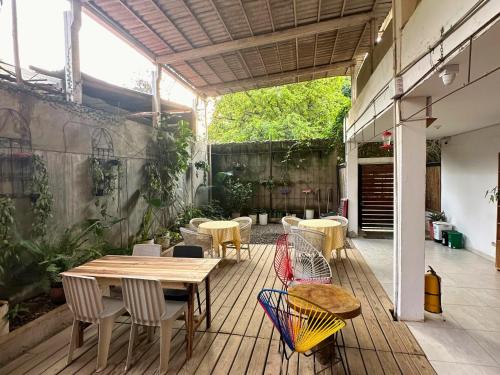 a patio with a wooden table and chairs at Casa Colibri Palomino in Palomino