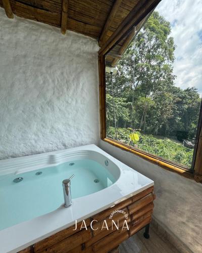 a bath tub in a room with a window at Terranest in Pereira