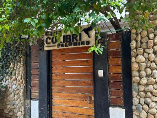 a wooden gate with a sign that reads cuisinart batting at Casa Colibri Palomino in Palomino