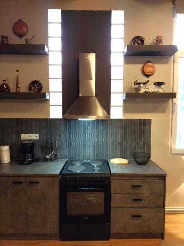 a kitchen with a stove and a stove top oven at Ammos House Katakolo - by the sea in Katakolon
