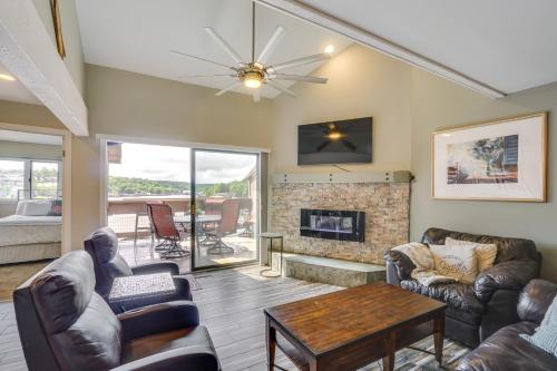 a living room with leather furniture and a fireplace at Boat Slip and Pools Waterfront Osage Beach Condo! in Osage Beach