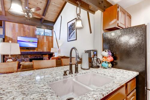 a kitchen with a sink and a living room at Lakeland Village 480 - Remodeled Close to Skiing 2BRLoft in South Lake Tahoe