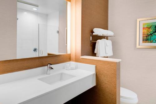 ein Badezimmer mit einem Waschbecken, einem WC und einem Spiegel in der Unterkunft Fairfield Inn & Suites by Marriott Bakersfield North/Airport in Bakersfield