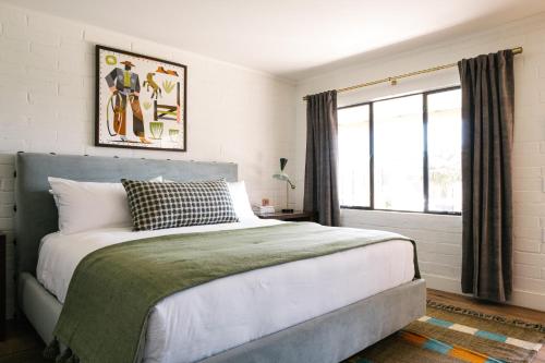 a bedroom with a large bed and a window at River Lodge Paso in Paso Robles