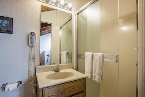 a bathroom with a sink and a shower with a mirror at Lakeland Village 603 Lakeview - See Ski Tahoe-Steps to Lake in South Lake Tahoe