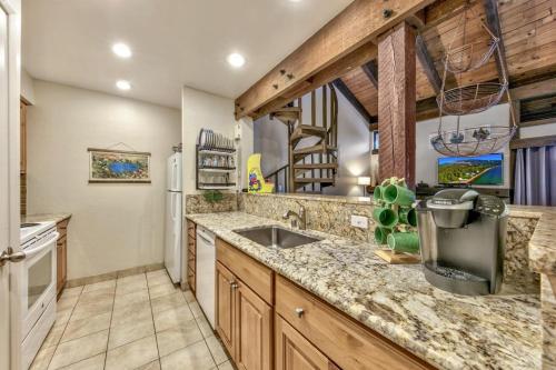 a kitchen with a sink and a stove at Lakeland Village 424 - I Lake It A Lot in South Lake Tahoe