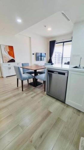 a kitchen and dining room with a table and chairs at Nicole House in Gò Công