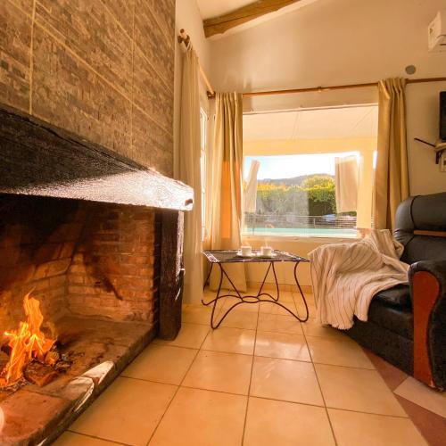a living room with a fireplace and a couch at no cc in Valle Grande