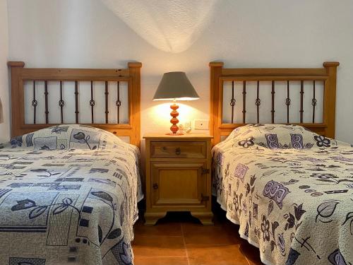 two beds sitting next to each other in a bedroom at Hotel Maria Luisa in Huajuapan de León