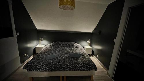 a bedroom with a bed with two pillows on it at Sunset Family Guesthouse Mont Saint Michel in Céaux