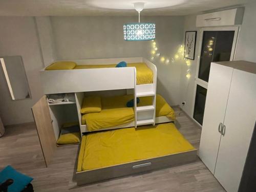 a small room with two bunk beds in it at Sunset Family Guesthouse Mont Saint Michel in Céaux