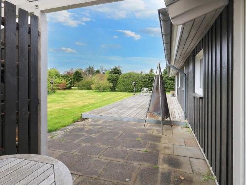 an outdoor patio with a table and bench on a house at 7 person holiday home in Fjerritslev-By Traum in Fjerritslev