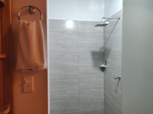 a bathroom with a shower with a glass door at HOTEL NIETO MOMPOX, ubicado en el corazón del centro histórico, frente al rio magdalena en zona de malecón in Mompos