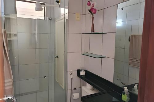 a bathroom with a mirror and a sink and a toilet at Apto em Tambaú no coração turístico da cidade ! in João Pessoa