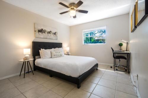 a bedroom with a bed and a ceiling fan at Sparkling Oasis near Downtown ST Pete/Beach in St. Petersburg