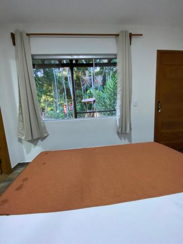 Katil atau katil-katil dalam bilik di Pousada Casa de Sapê