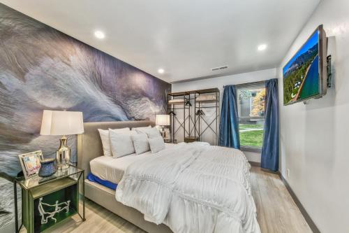 a bedroom with a bed and a painting on the wall at Lakeland Village 468 Modern Marvel in South Lake Tahoe