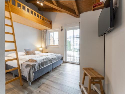 a bedroom with a bunk bed and a tv at Luxury Tauern Suite Walchen-Kaprun 3 in Piesendorf