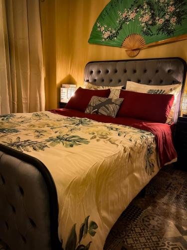 a bedroom with a large bed with a large flower painting on the wall at ORHO Hotel Boutique 15 minuts PTY Airport free shuttle in Tocumen