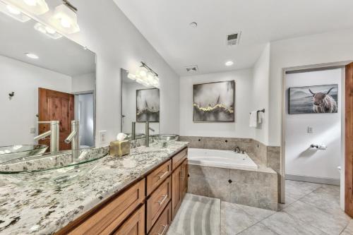 a bathroom with two sinks and a tub and a shower at Tahoe Woods 501 - Location Spacious Walk to Beach in South Lake Tahoe