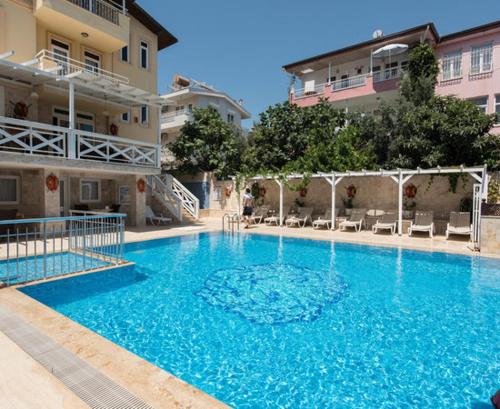 a large blue swimming pool in front of a building at Noo 15 in Side