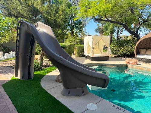 a water slide in front of a swimming pool at The Buddha Estate in Las Vegas