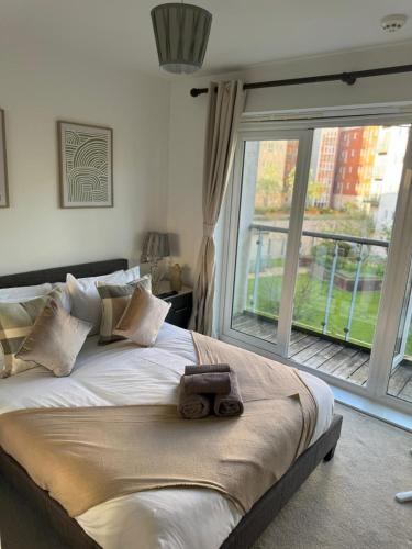 a bedroom with a large bed with a large window at Tidy Nights in Southampton
