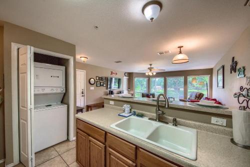 a kitchen with a sink and a white refrigerator at WW F101 Slice of Heaven in New Braunfels