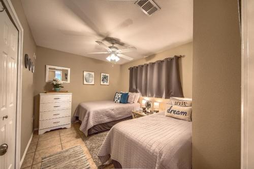 a bedroom with two beds and a ceiling fan at WW F101 Slice of Heaven in New Braunfels