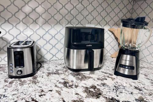 a blender and a toaster sitting on a counter at Pocono Mountains Luxury Retreat with king bed & game room in Cresco